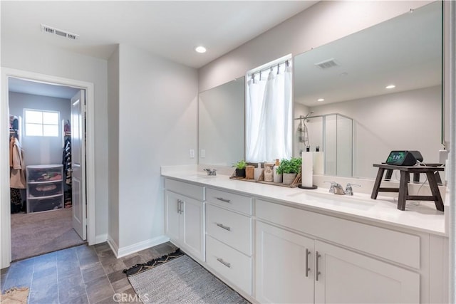 bathroom featuring vanity and a shower with shower door