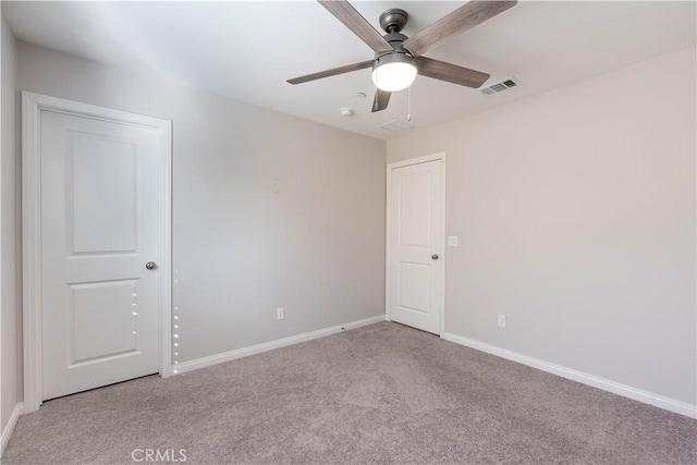 empty room with light colored carpet and ceiling fan