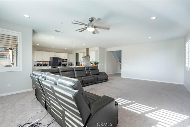 living room featuring ceiling fan and light carpet