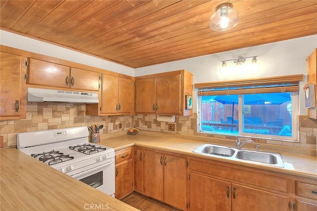 kitchen featuring sink, backsplash, wood ceiling, and white gas range oven