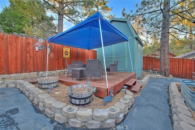view of patio with a fenced backyard, a deck, and outdoor dining area