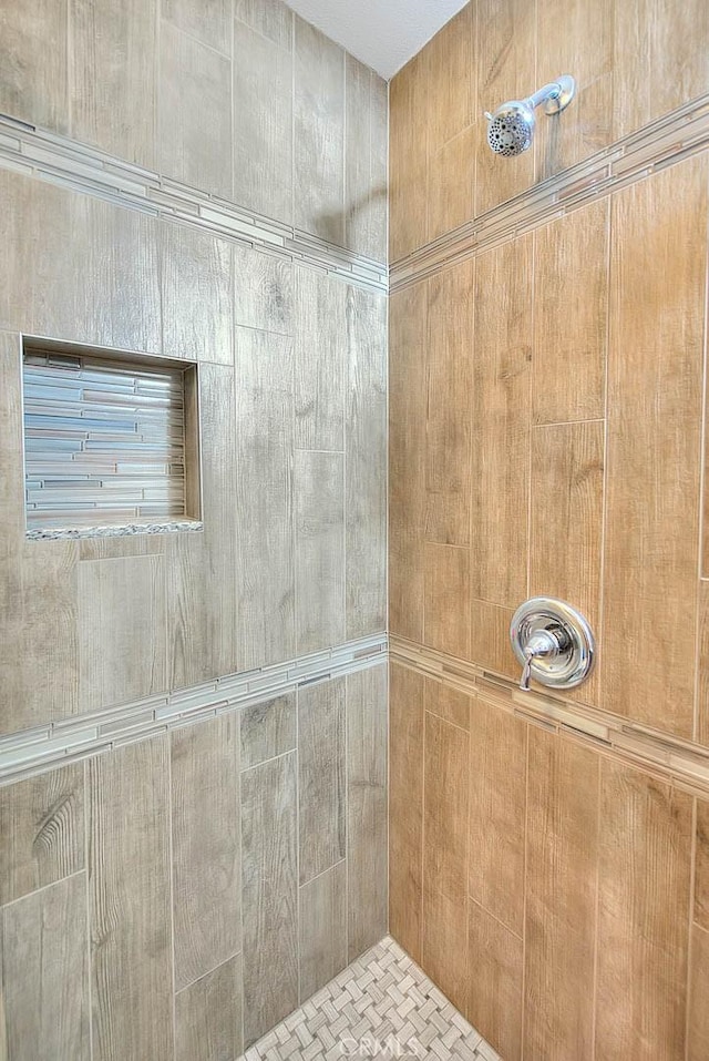 full bathroom with a tile shower
