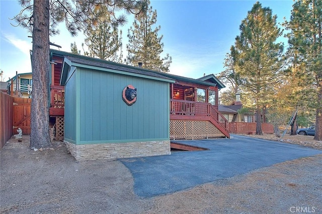 view of outdoor structure with fence and stairs