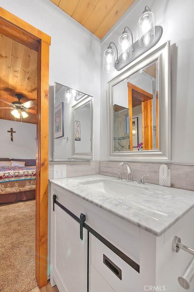 bathroom featuring wooden ceiling, ensuite bath, vanity, and ceiling fan