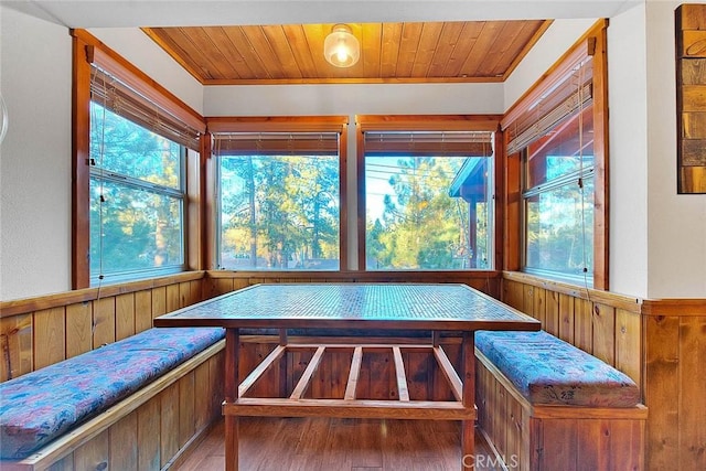 unfurnished sunroom featuring wood ceiling and breakfast area