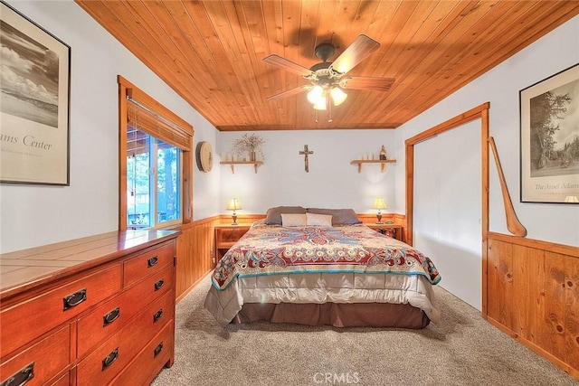 bedroom featuring ceiling fan, light carpet, and wooden ceiling