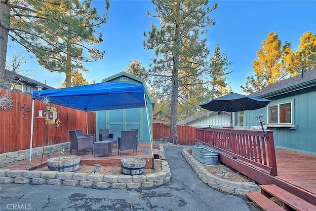view of patio with a fenced backyard and a deck