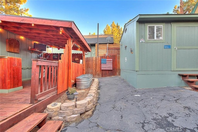 exterior space with fence, an outbuilding, and a storage unit