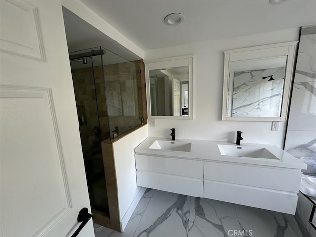 bathroom with vanity and a shower with shower door