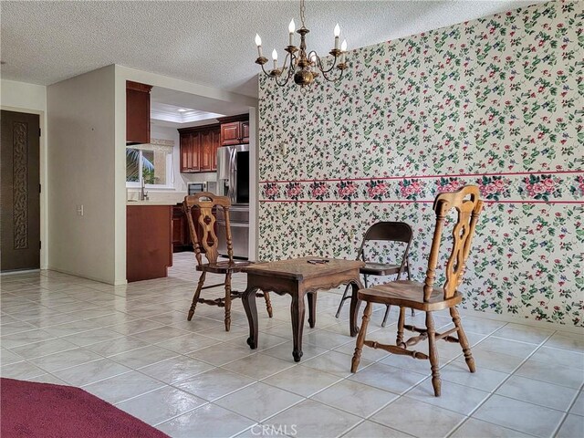 tiled dining area featuring a textured ceiling and an inviting chandelier