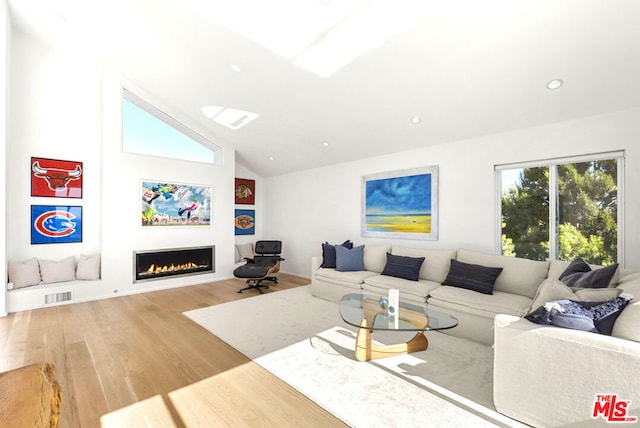 living room with hardwood / wood-style floors and lofted ceiling