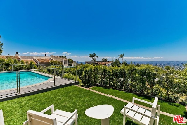 view of swimming pool featuring a lawn