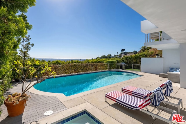 view of pool featuring outdoor lounge area and a patio