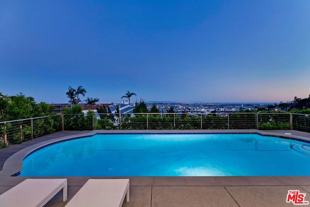 view of pool at dusk