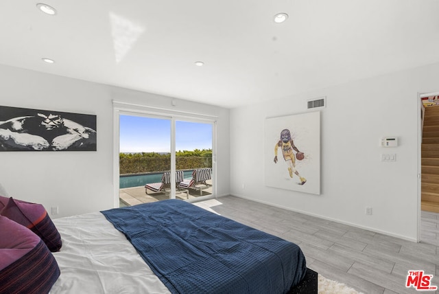 bedroom featuring access to exterior and light hardwood / wood-style floors