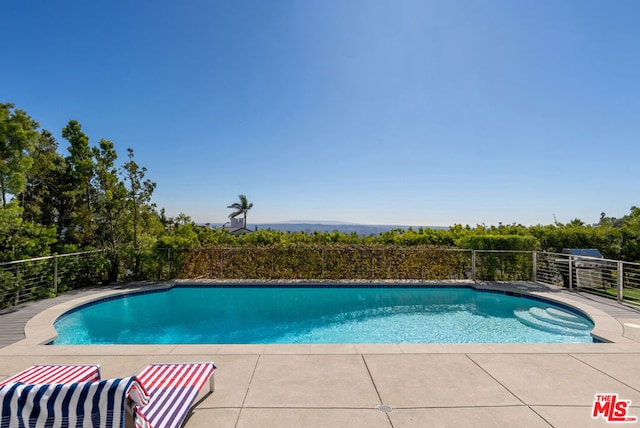 view of swimming pool featuring a patio