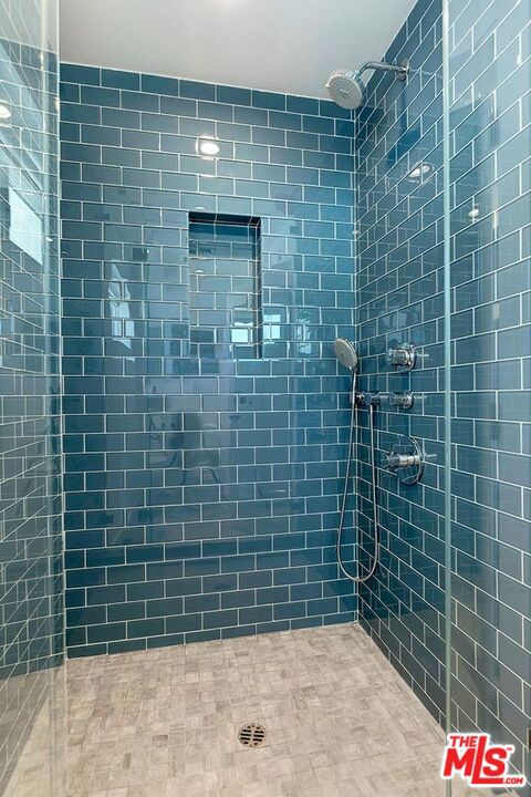 bathroom with a tile shower