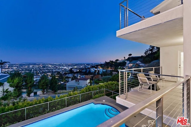 view of pool at dusk