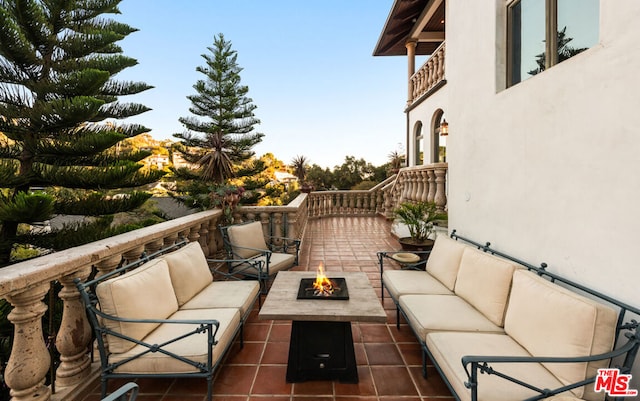 view of patio / terrace with an outdoor living space with a fire pit