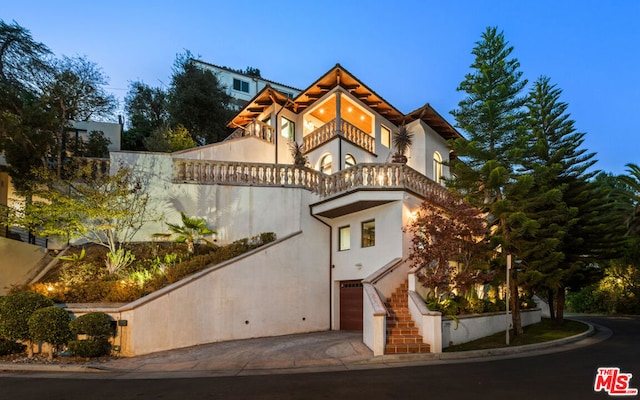 view of front of home with a balcony and a garage