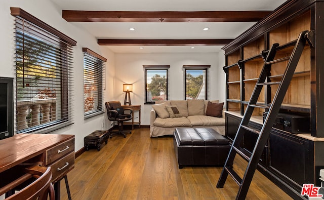 living area with light hardwood / wood-style flooring and beamed ceiling