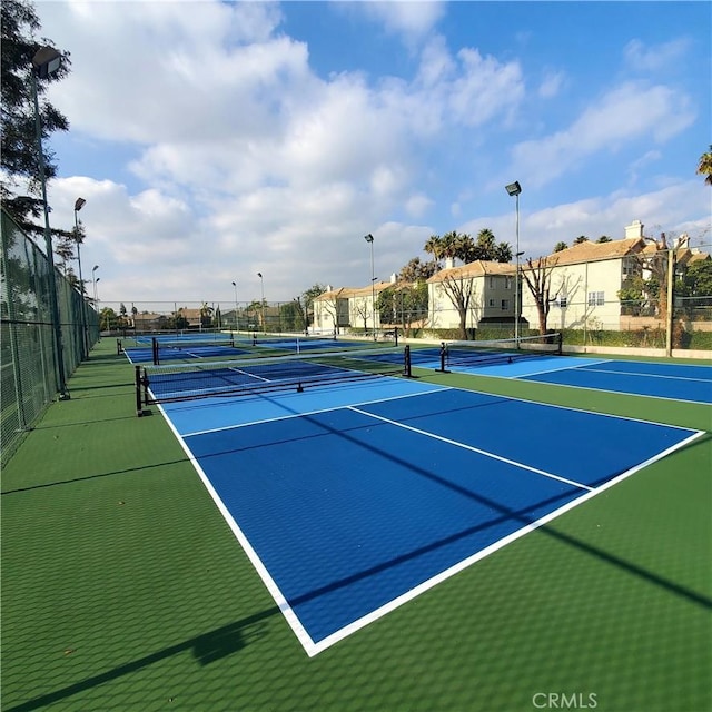 view of tennis court featuring basketball hoop