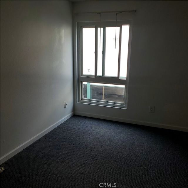 unfurnished room featuring carpet flooring