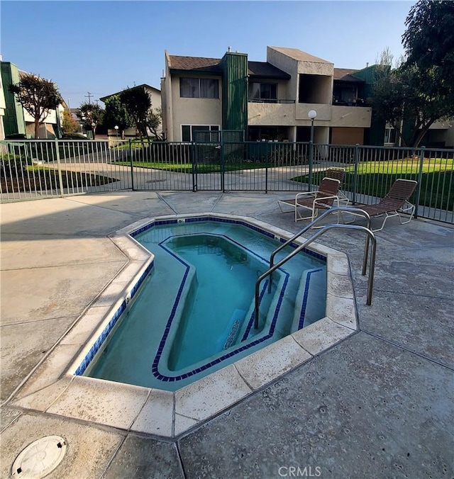 view of swimming pool featuring a community hot tub