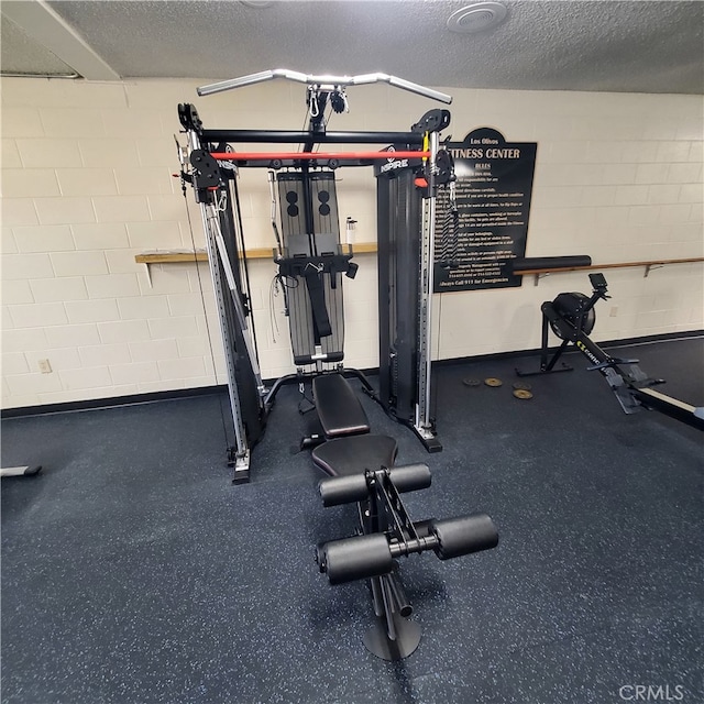 exercise room with a textured ceiling