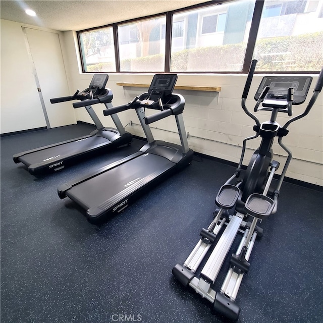 workout area featuring a textured ceiling