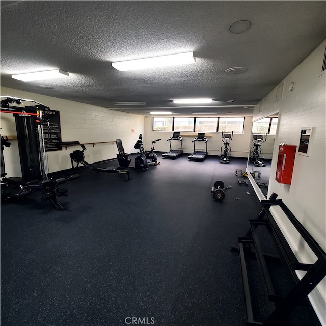 gym featuring a textured ceiling