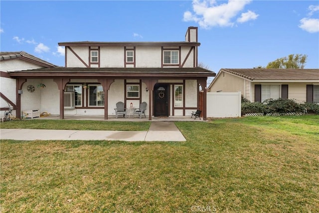 english style home with a front lawn and a porch