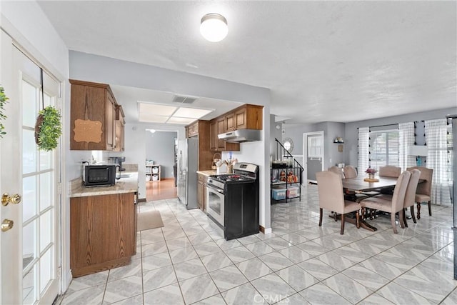 kitchen with appliances with stainless steel finishes and light stone countertops