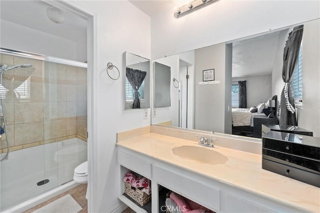 bathroom featuring vanity, tile patterned floors, toilet, and walk in shower