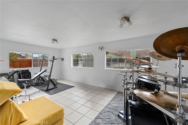 exercise room with light tile patterned flooring