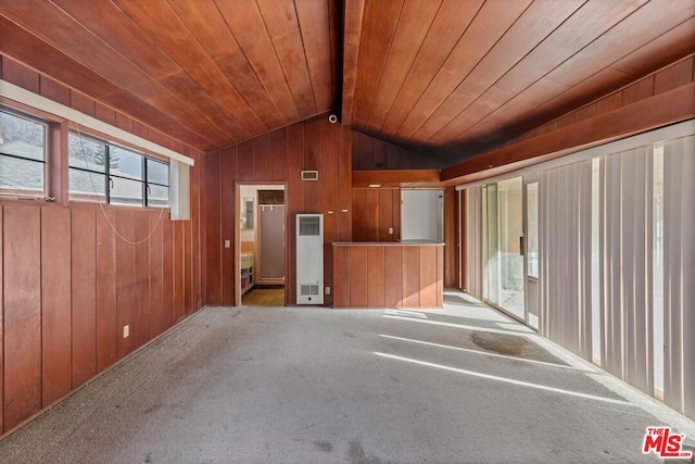 interior space with light carpet, lofted ceiling with beams, wooden walls, and wooden ceiling