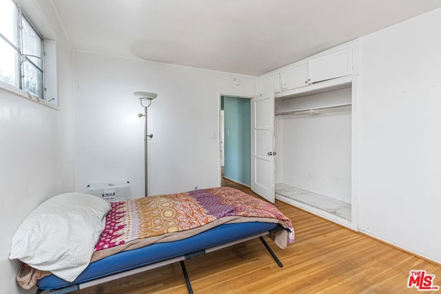 bedroom featuring a closet and light wood-type flooring