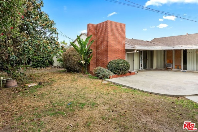 exterior space with a yard, a patio, and cooling unit