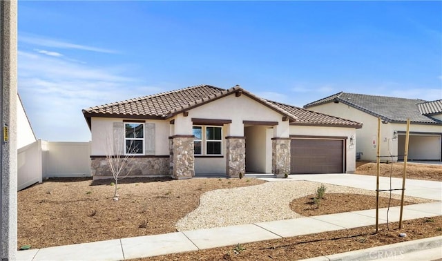 view of front of house featuring a garage, stone siding, driveway, and stucco siding