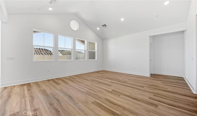 unfurnished room featuring light wood finished floors, recessed lighting, visible vents, high vaulted ceiling, and baseboards