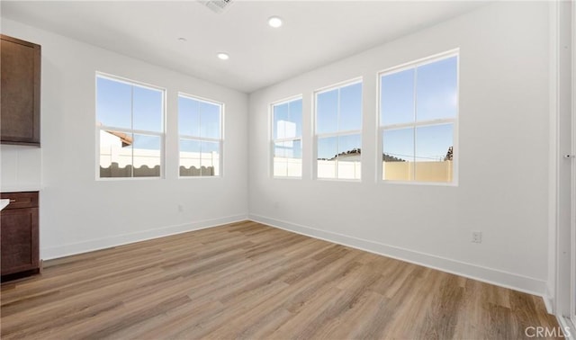 spare room featuring recessed lighting, baseboards, visible vents, and light wood finished floors