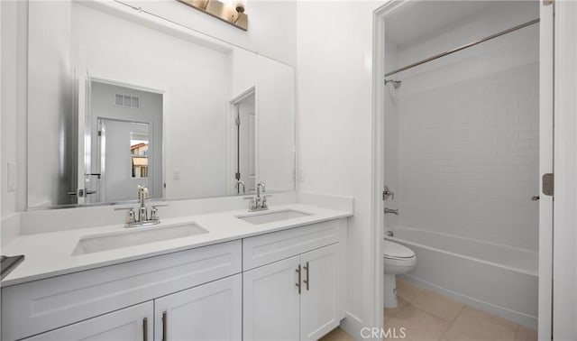 bathroom featuring tile patterned flooring, washtub / shower combination, visible vents, and a sink