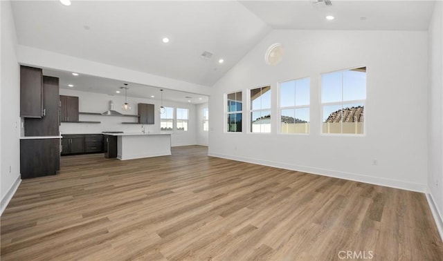 unfurnished living room with light wood-style floors, baseboards, and recessed lighting