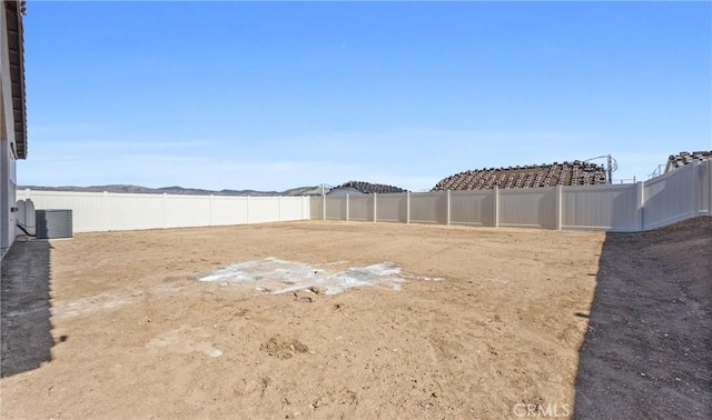 view of yard with cooling unit and fence