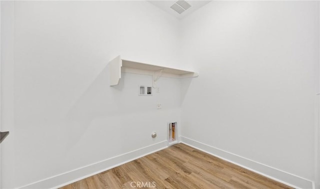 laundry area featuring laundry area, light wood finished floors, baseboards, visible vents, and washer hookup