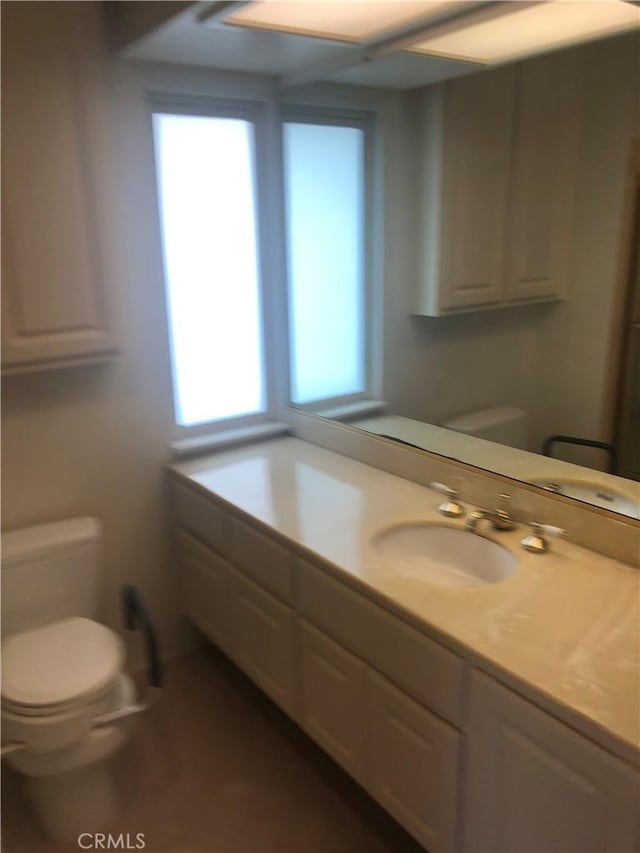 bathroom featuring vanity and toilet