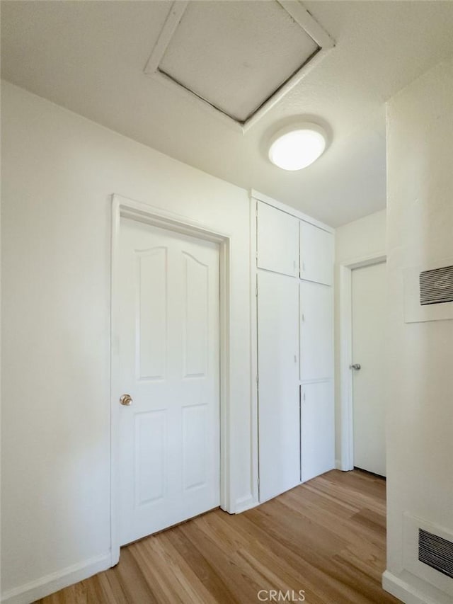 unfurnished bedroom with a closet and light hardwood / wood-style flooring