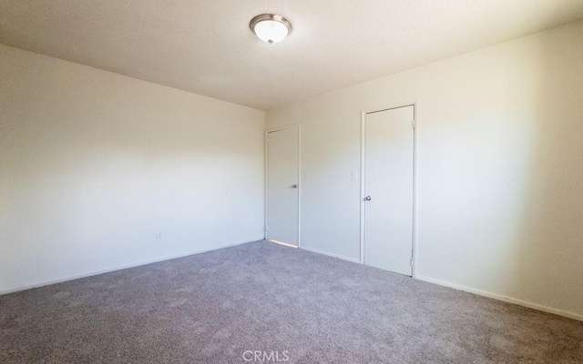 unfurnished bedroom with carpet and a closet