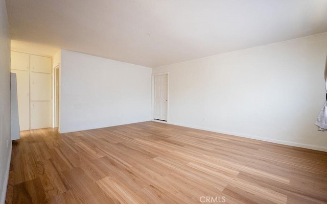 spare room featuring light wood-type flooring