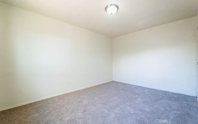 unfurnished room with carpet flooring